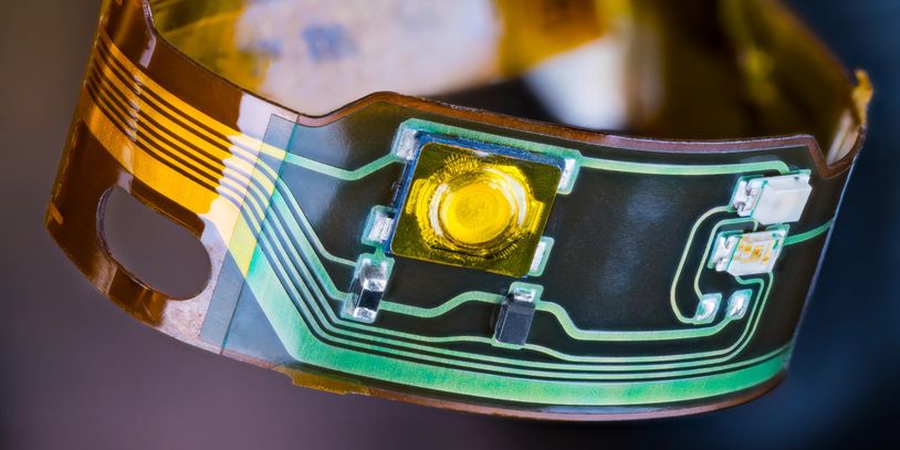 Flex/PWB circuit board in yellow substrate, representing advanced high-reliability fabrication.
