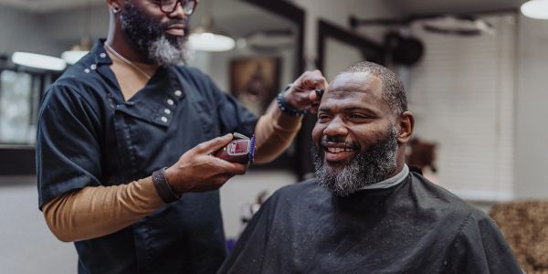 Man getting a haircut with clippers.