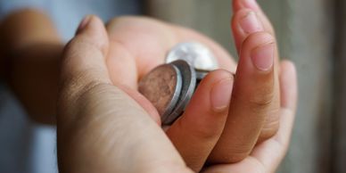 Hand holding some coins.