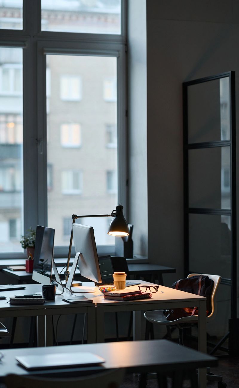 Vertical image of empty dark IT office with computers