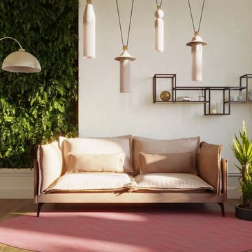 Modern living room with beige sofa, green plants, and stylish lighting.