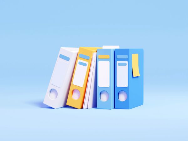 Colorful binders arranged against a blue background.