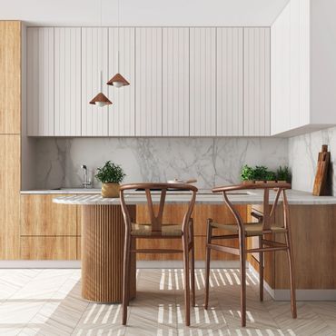 Modern kitchen with wood and marble finishes and two wooden chairs at the island.