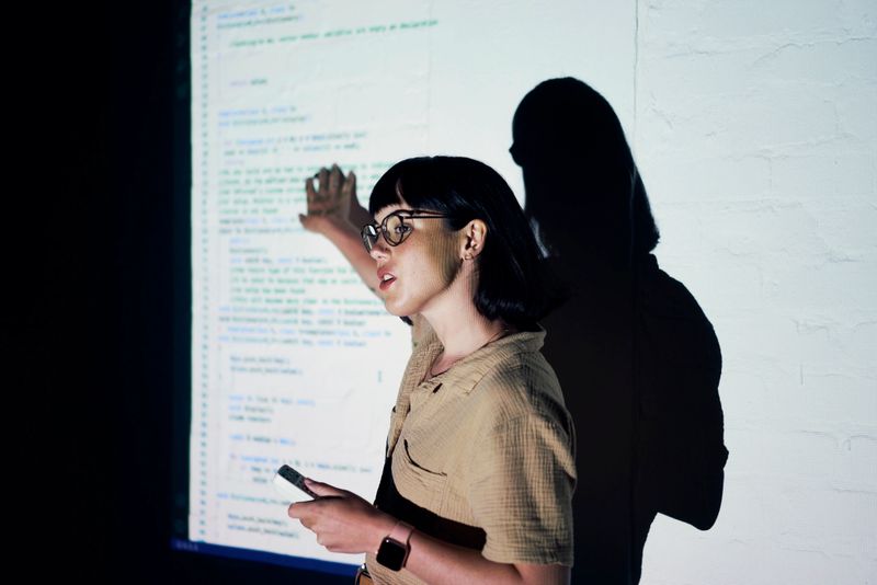 Seminar, lecture or software presentation with woman teaching IT or tech coding for web developer. Workshop, research and cyber security code trade show, sharing and planning future technology ideas.