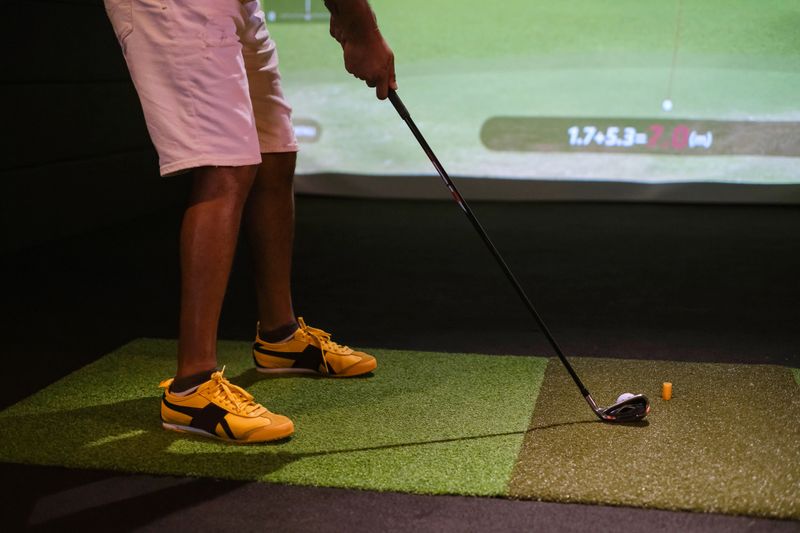 Close up shot of unrecognizable man playing golf simulator