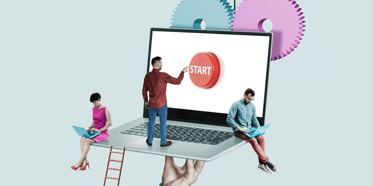 Miniature people working on a giant laptop with a start button and gears symbolizing innovation.