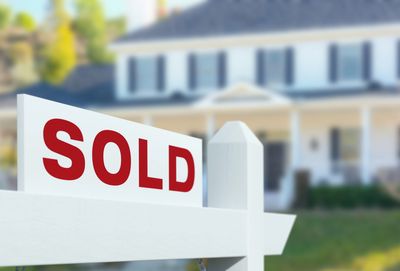 Sold Sign in front of house.