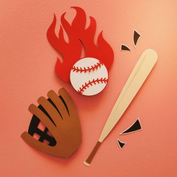 Paper art of flaming baseball, bat, and glove on orange background.