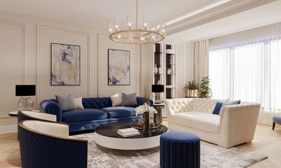 Elegant living room with blue and cream sofas, modern lighting, and abstract wall art.