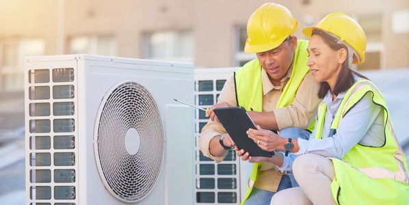Hand adjusting a smart thermostat set to 66°F.