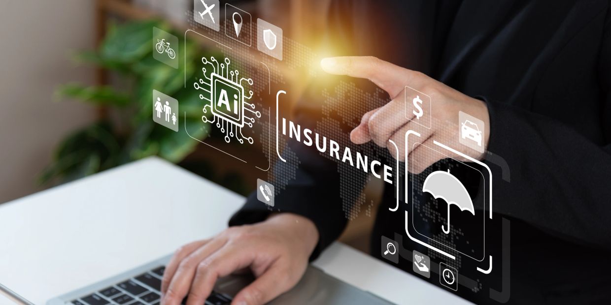 Person interacting with AI-powered insurance icons on a laptop interface.