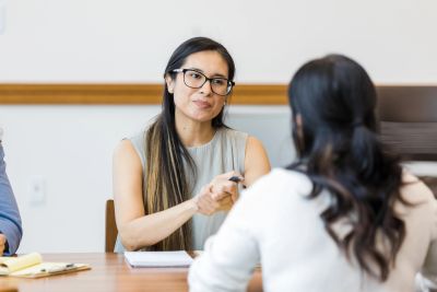 Experienced Arizona family law attorney meeting with a client to discuss post-decree modifications, 