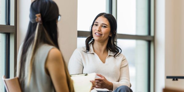 Therapist speaking with client during anxiety therapy session.