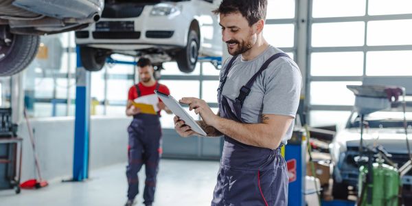 Two mechanics working in an auto repair shop.