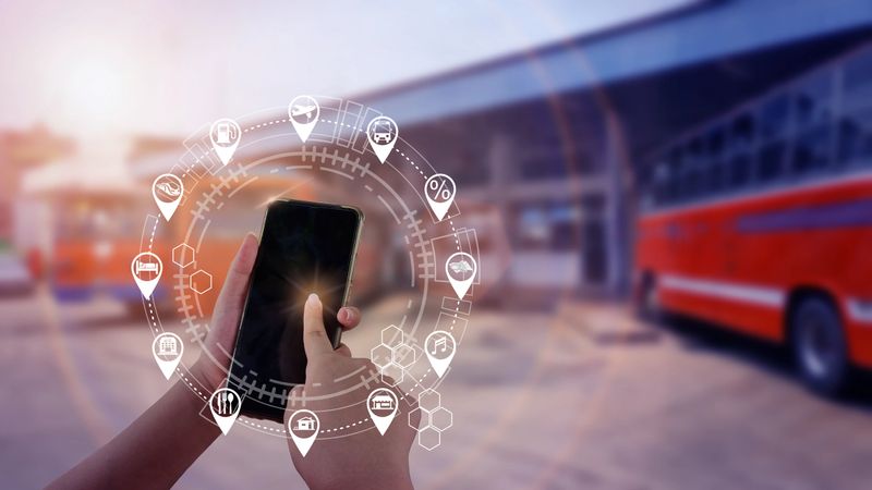 Tourist is using mobile internet (iot) on his smartphone at bus station, business trip, travel icon.