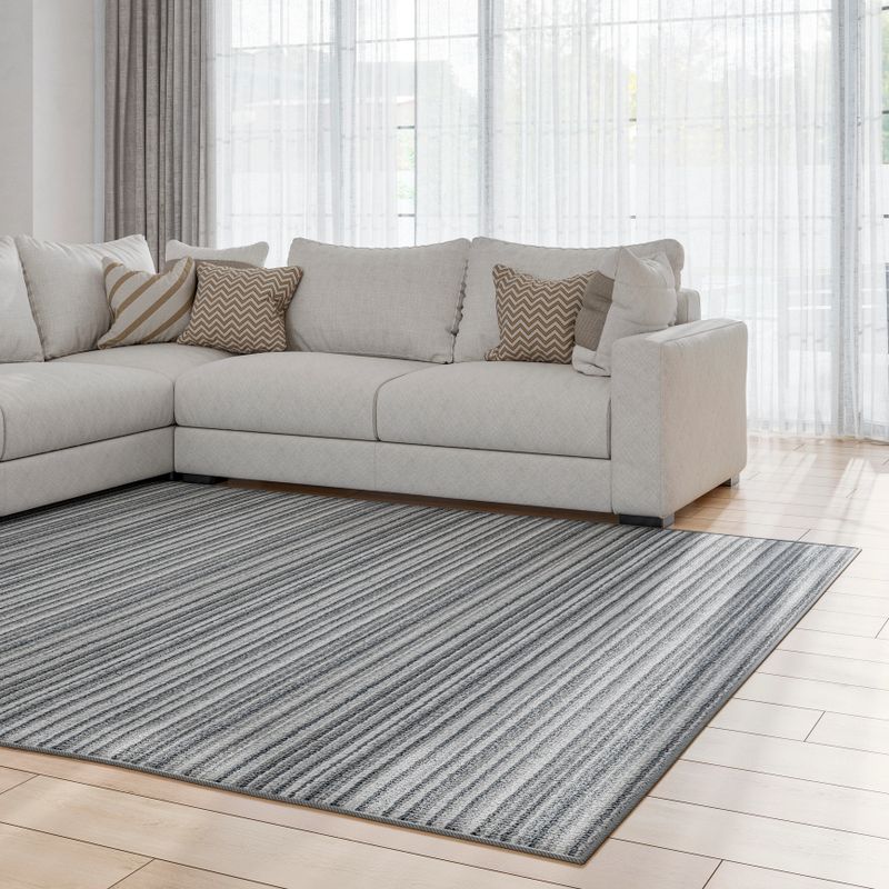 Side view of an elegant living room with a beige textile sofa and pillows on the hardwood parquet floor with a gray striped carpet in front and copy space for a product.  Large retro black and golden window doors with white and beige curtains in the background. A slight vintage effect is added. 3D rendered image.