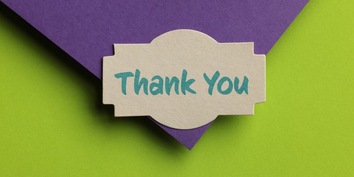 A thank you note on a purple and green background.