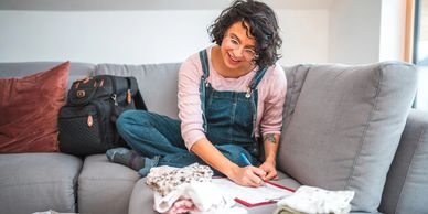 Adult reviewing and taking notes while organizing clothes for Cola Kids Consignment Grown-Ups sale