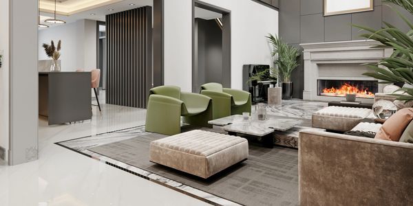 Modern living room with high ceilings, green chairs, and a fireplace.
