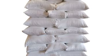 Stack of white sacks on a wooden pallet.
