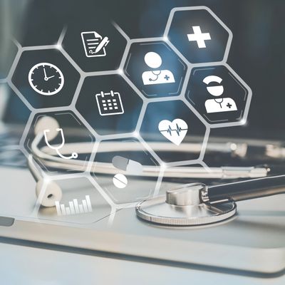 Medical icons overlaying a stethoscope on a laptop keyboard.