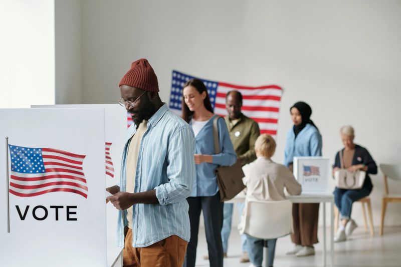 A diverse group of voters casting their ballots at a local polling station.