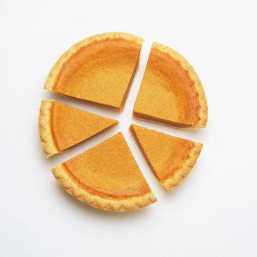 A sliced round pumpkin pie.