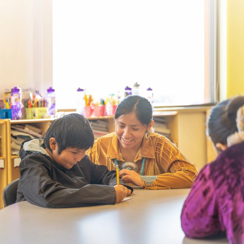 Indigenous Navajo Cheerful teacher checking her student progress