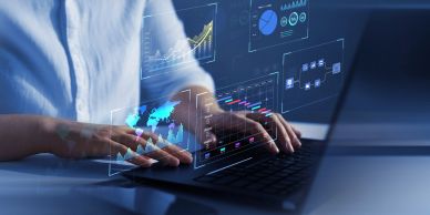 Person using laptop with digital data holograms.