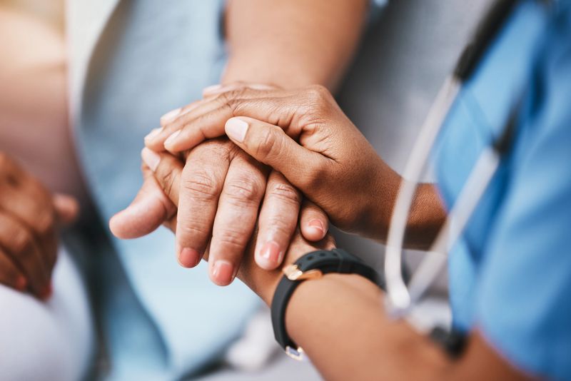 Empathy, trust and nurse holding hands with patient for help, support and support and healthcare advice. Kindness, counseling and medical therapy in nursing home for hope, consultation and psychology
