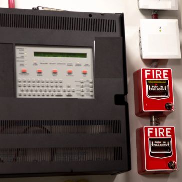 Fire alarm control panel with two pull-down fire alarms.