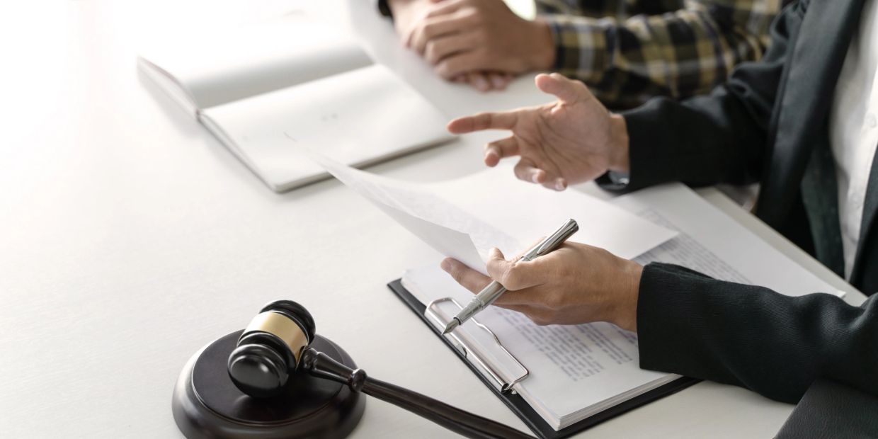 Legal consultation with gavel, documents, and discussion.