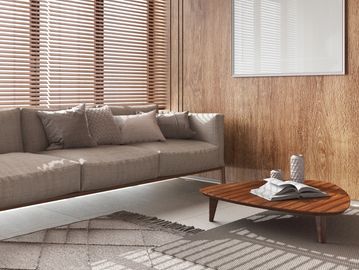 Cozy living room with beige sofa, wooden coffee table, and natural light through blinds.
