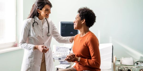 Doctor comforting patient during consultation.
