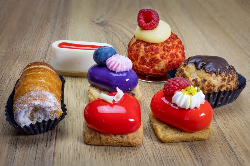 tasty various colorful pastries on wooden table