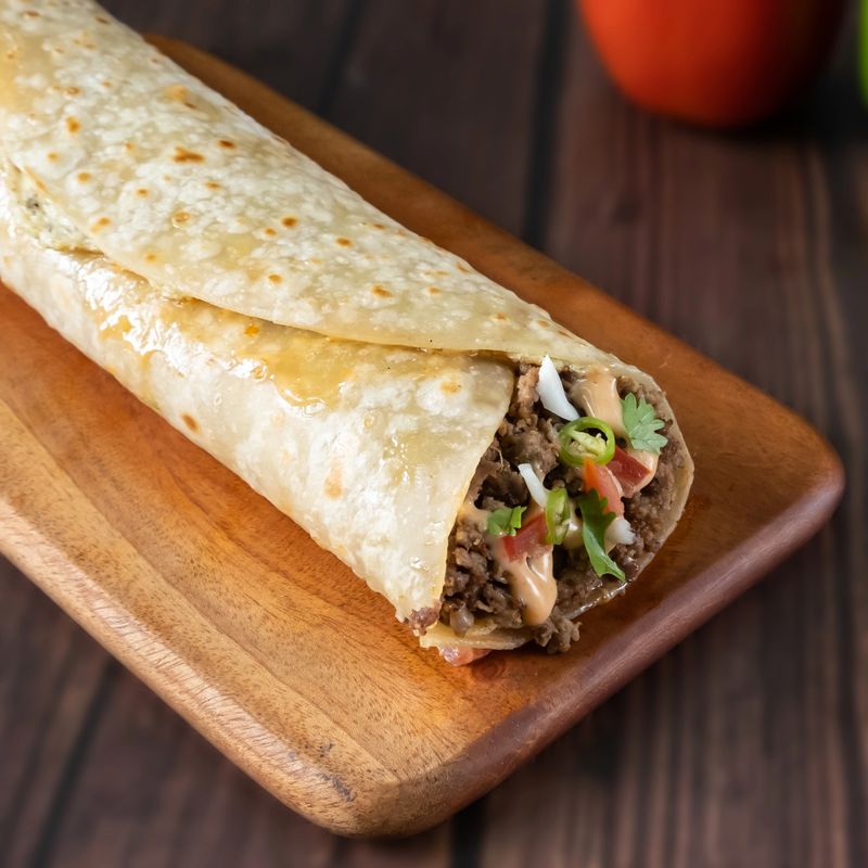 Arab Minced Beef Wrap paratha roll served in wooden board side view of indian fastfood