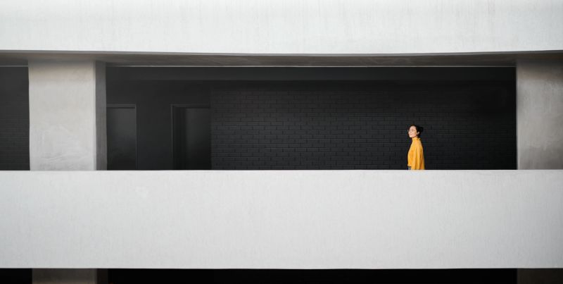Thinking, inspiration and woman in a work building for a goal, motivation and idea for an agency. Calm, success and Asian employee with a vision for an architecture company walking in a corridor