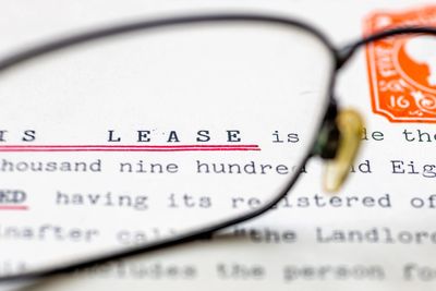 Close-up view of a lease document through glasses.