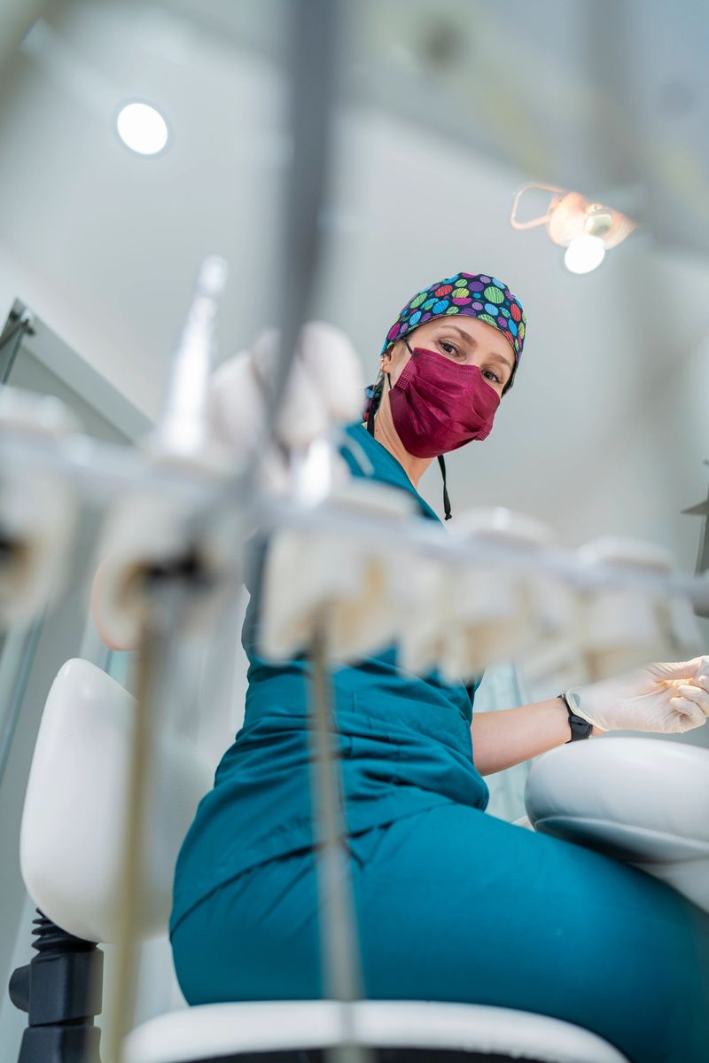Beautiful Latino dentist from Bogota Colombia between the ages of 40 and 49 arriving at the office and preparing the dental fixtures while wearing her uniform