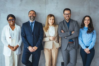Corporate men and women smiling