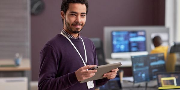 Man holding a tablet in an office.