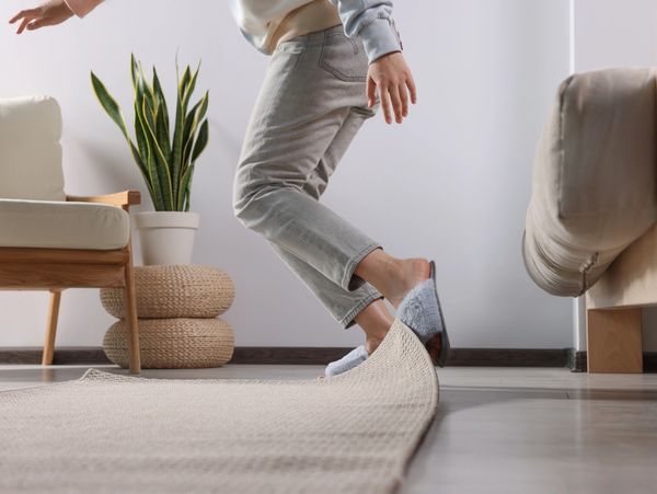 Person tripping on a rug in a cozy living room.