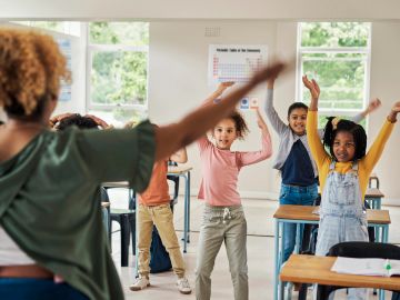 Children doing exercises in a classroom.