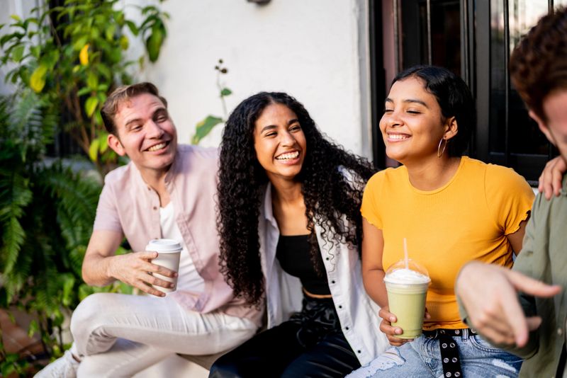 Happy friends talking at home