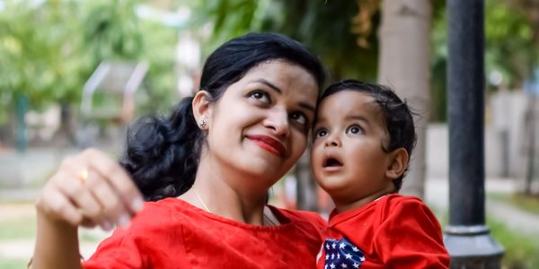 Mother and child in red clothing enjoying time outdoors.