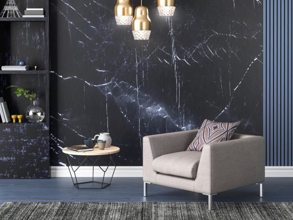Modern living room with armchair and marble wall.