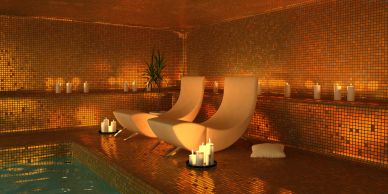 Luxury spa room with candles and modern chairs.