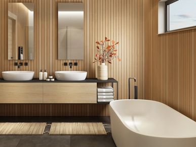 Modern bathroom with wooden walls, dual sinks, and a freestanding bathtub.