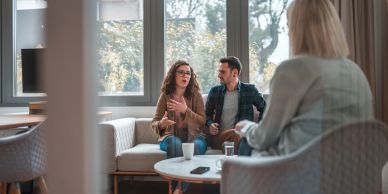 Couple discussing with counselor in therapy session.