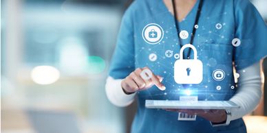 Healthcare professional using tablet with digital security icons.